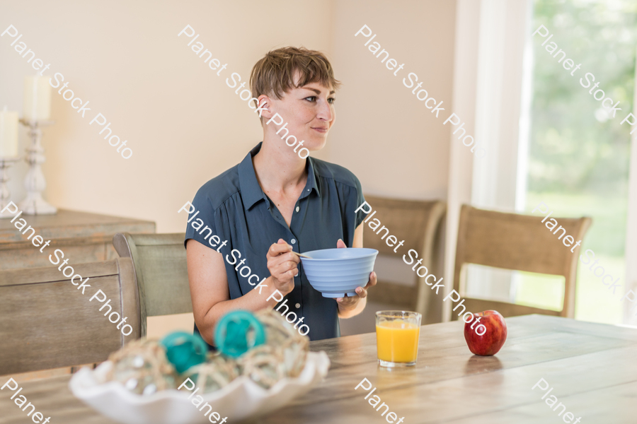 A young lady having a healthy breakfast stock photo with image ID: 3ad99bc7-b1de-4828-8367-3cd6f24487fe