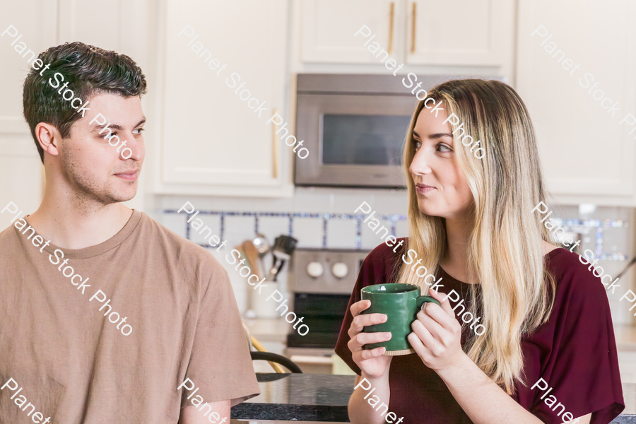 A young couple sitting and enjoying hot drinks stock photo with image ID: 3b1460a3-9a60-4f6f-bc08-45c2c2f02b84