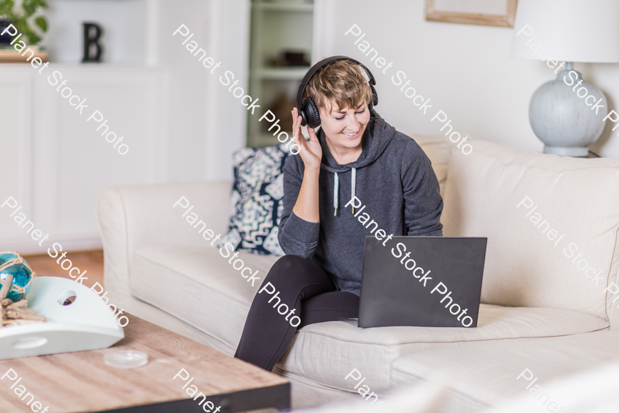 A young lady sitting on the couch stock photo with image ID: 3c8712b8-9c70-4467-b939-e15c67073dc1