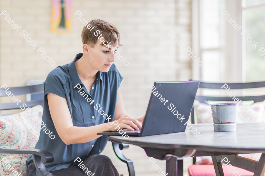 A young lady enjoying daylight at home stock photo with image ID: 3cc38213-8ad4-4ace-86f4-420e15c60407