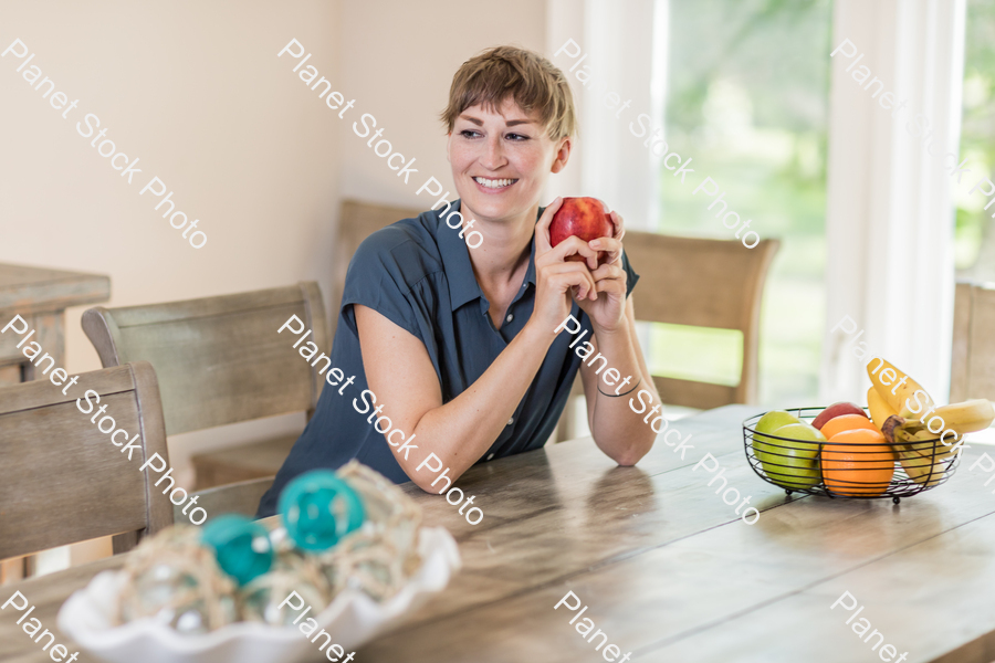 A young lady grabbing fruit stock photo with image ID: 3cecfffa-ebf2-4d1e-825a-cc2c88578d44