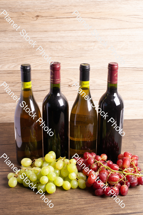 Four bottles of wine, with grapes stock photo with image ID: 3dcd047a-36f9-415a-94d4-ca0416da24ef