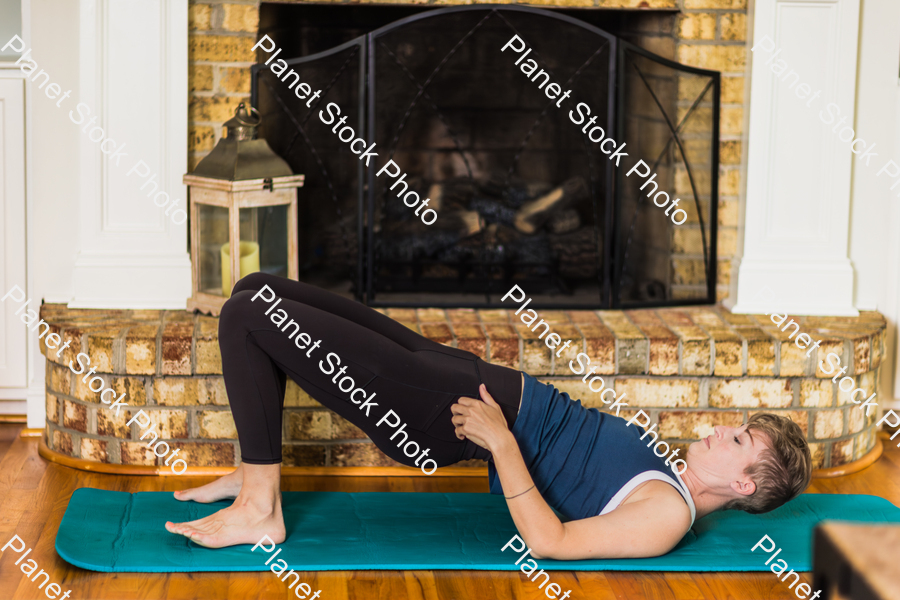A young lady working out at home stock photo with image ID: 3e99a76b-7ff4-4a80-8f21-8b1bf3cb9e45
