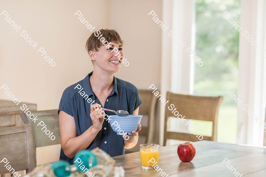 A young lady having a healthy breakfast stock photo with image ID: 409ff034-ab42-4412-ac58-247f09ddda66