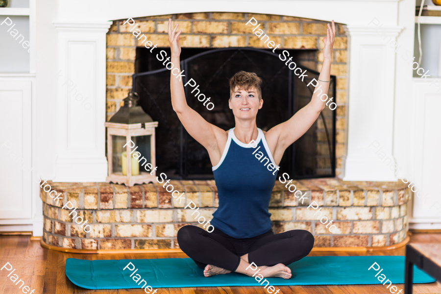 A young lady working out at home stock photo with image ID: 4132ec39-1477-4ad2-a99d-bd2bd2bce581