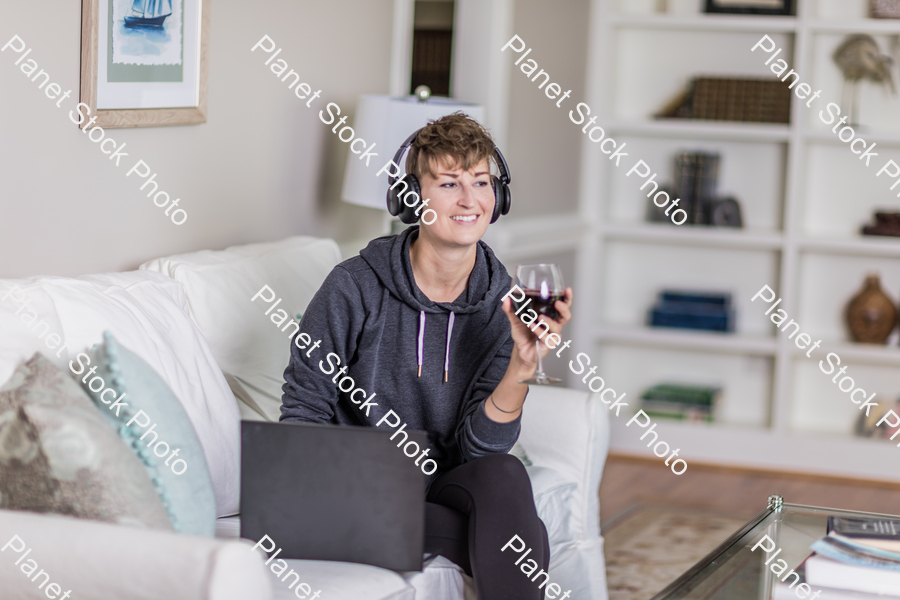 A young lady sitting on the couch stock photo with image ID: 41a784ac-0bdf-4e8d-be2d-21f385c9dddc