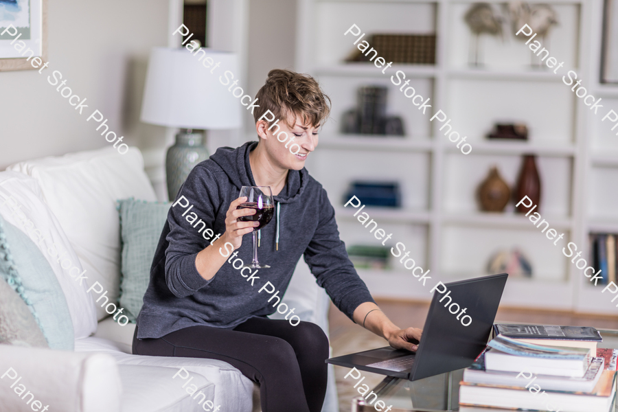 A young lady sitting on the couch stock photo with image ID: 42af3630-27c2-4afb-a92b-9f068c9e2658