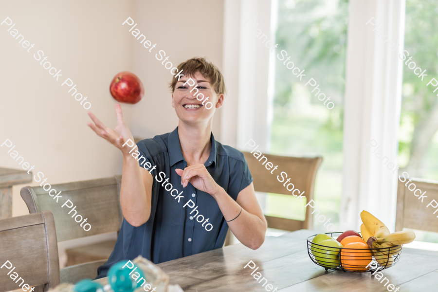 A young lady grabbing fruit stock photo with image ID: 43056747-5572-4928-92f7-d2a3e634297b