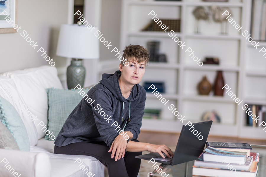 A young lady sitting on the couch stock photo with image ID: 4448811c-3703-4f94-a10c-b0283895bebe