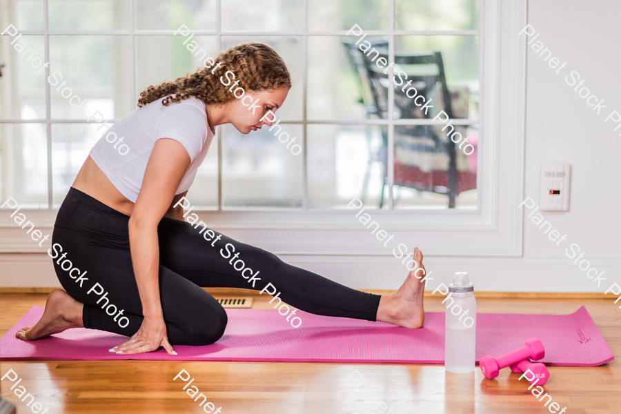 A young lady working out at home stock photo with image ID: 45783fdd-098d-4894-9295-555195069057