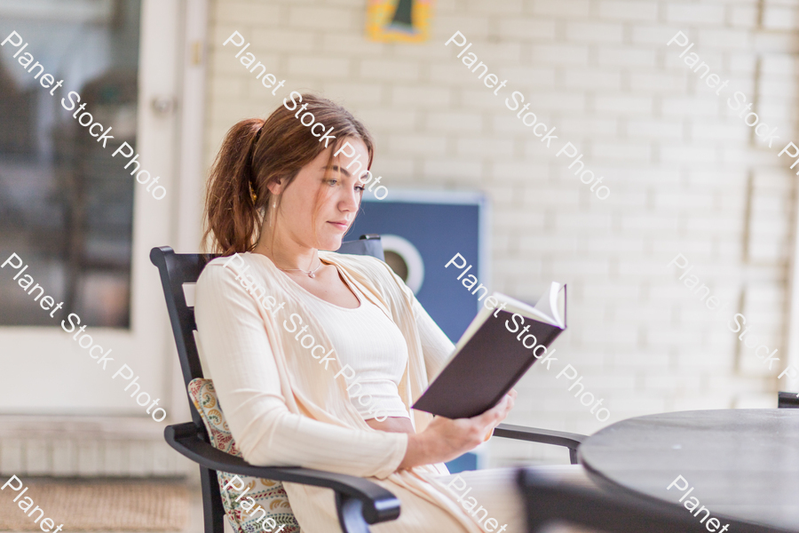 A young lady enjoying daylight at home stock photo with image ID: 45ab3bf7-5fe8-4caa-be6f-4d9acd28f691