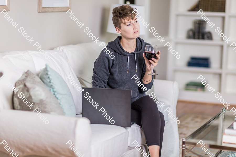 A young lady sitting on the couch stock photo with image ID: 460716bc-a184-4e15-b58c-e3b02c1f1c1b