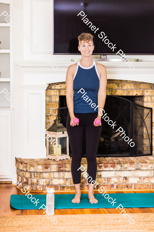 A young lady working out at home stock photo with image ID: 468b8e8d-27e5-4f95-a678-3345c5c9ec24