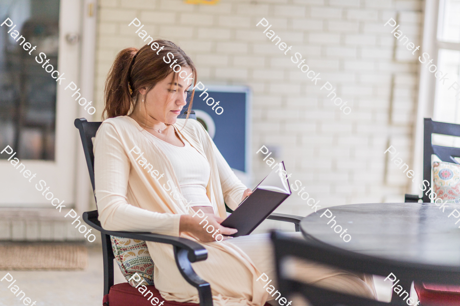 A young lady enjoying daylight at home stock photo with image ID: 4a221ce7-14ca-479f-8b90-c28b7bdb3c20