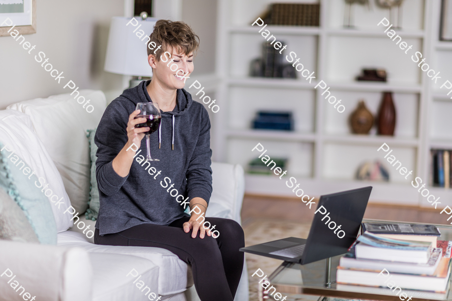A young lady sitting on the couch stock photo with image ID: 4ad88ae2-16db-42db-9bf2-a7f43b0ba2b8
