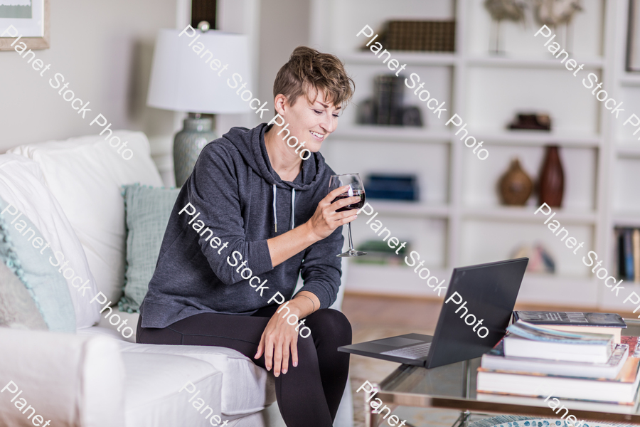 A young lady sitting on the couch stock photo with image ID: 4ccb205b-d022-4e8c-a637-37ffd3acdc56