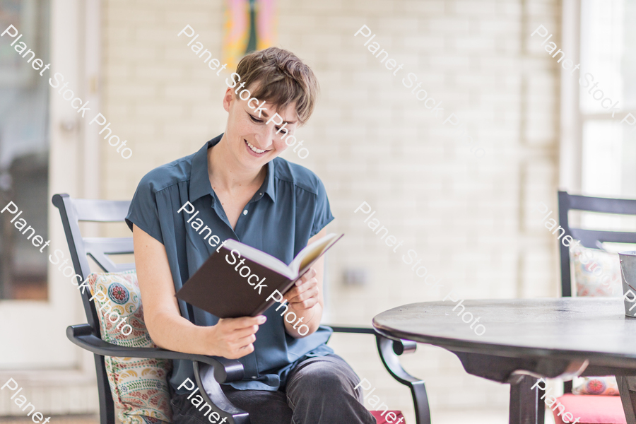 A young lady enjoying daylight at home stock photo with image ID: 4d252aad-adb6-4dd2-b6ed-94501ff2f60c