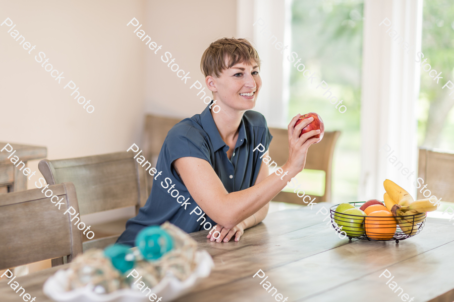A young lady grabbing fruit stock photo with image ID: 4db69061-218b-436a-8623-6cd77bf13a50