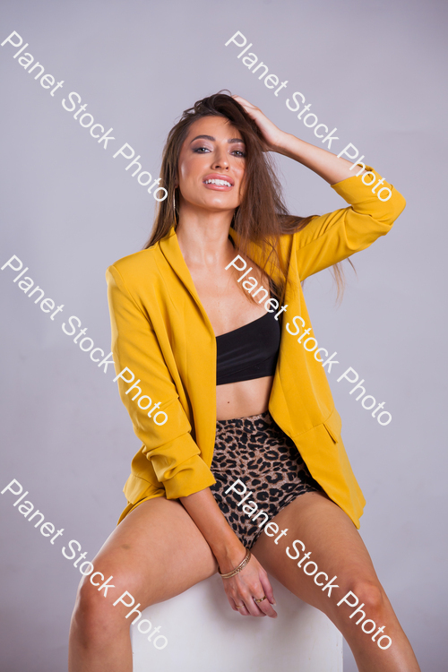 Model wearing yellow jacket, posing for a studio photoshoot stock photo with image ID: 4e6fae2d-0fa6-4117-9876-5980d857585d
