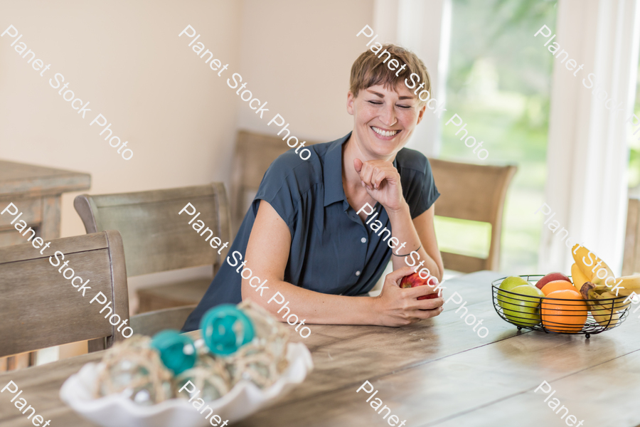 A young lady grabbing fruit stock photo with image ID: 4f1a7d2f-53d7-4769-a17f-49dde0f7d94a