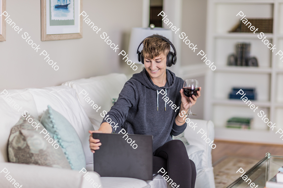 A young lady sitting on the couch stock photo with image ID: 4fd1b08f-6cb4-4101-88a5-b9a727afa0f8