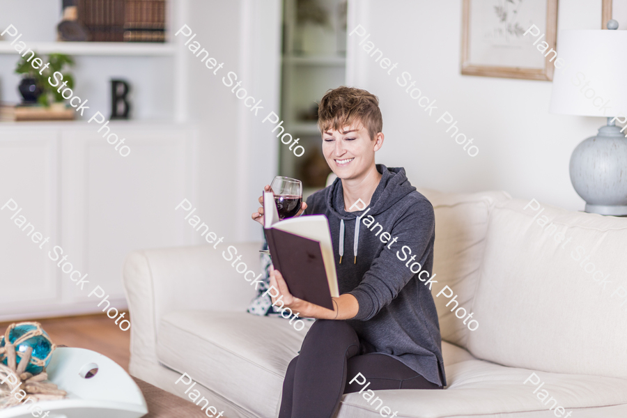 A young lady sitting on the couch stock photo with image ID: 51bf122f-5636-42e4-8bbc-f907ce350556