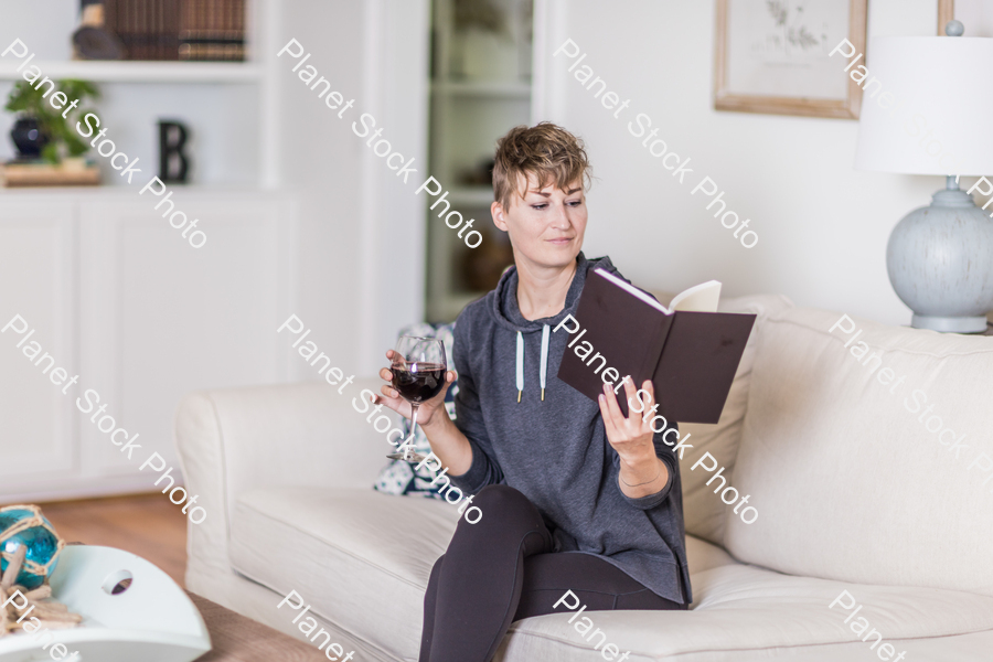 A young lady sitting on the couch stock photo with image ID: 51d79435-6982-48f1-a29d-3ddef2591fb6