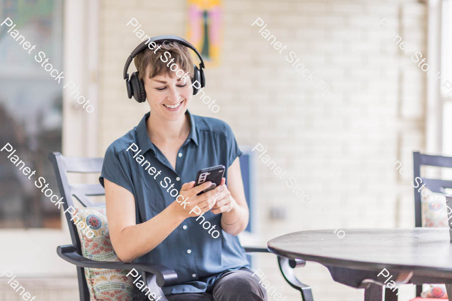 A young lady enjoying daylight at home stock photo with image ID: 52de3e5f-394f-441a-88f8-917aec8cd716