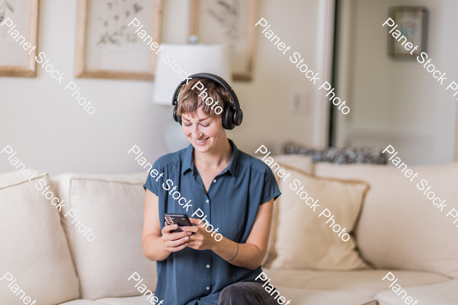 A young lady sitting on the couch stock photo with image ID: 52e0d787-2a65-4620-89bd-153403bb1e0c