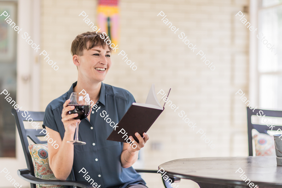 A young lady enjoying daylight at home stock photo with image ID: 53f6dc5e-c5cd-4c7e-a8c2-ec4b44fb34b3