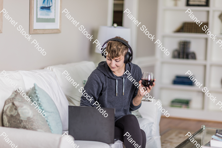 A young lady sitting on the couch stock photo with image ID: 544dc69c-4662-4446-9e17-64a46676e307