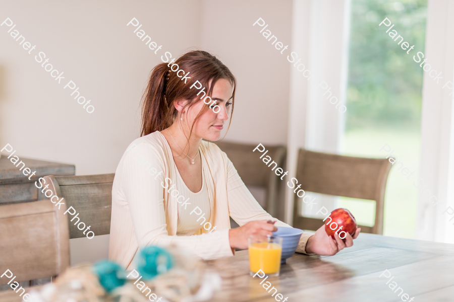 A young lady having a healthy breakfast stock photo with image ID: 57eb47b0-072e-46cf-83ee-77e24cc488de