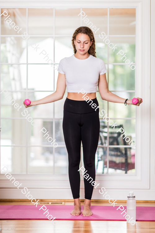 A young lady working out at home stock photo with image ID: 58c14da2-adf7-4c70-904f-a79892581e8e