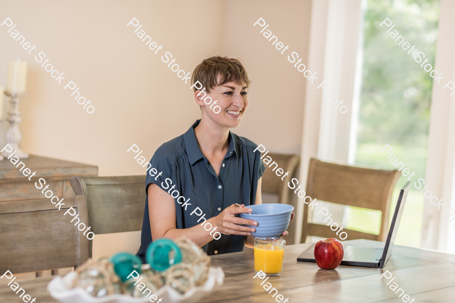 A young lady having a healthy breakfast stock photo with image ID: 5957471a-1b05-46ef-afd5-2e3f44325928