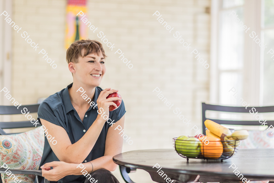 A young lady enjoying daylight at home stock photo with image ID: 596a5152-dffe-4609-9960-b3ba6a14a70d