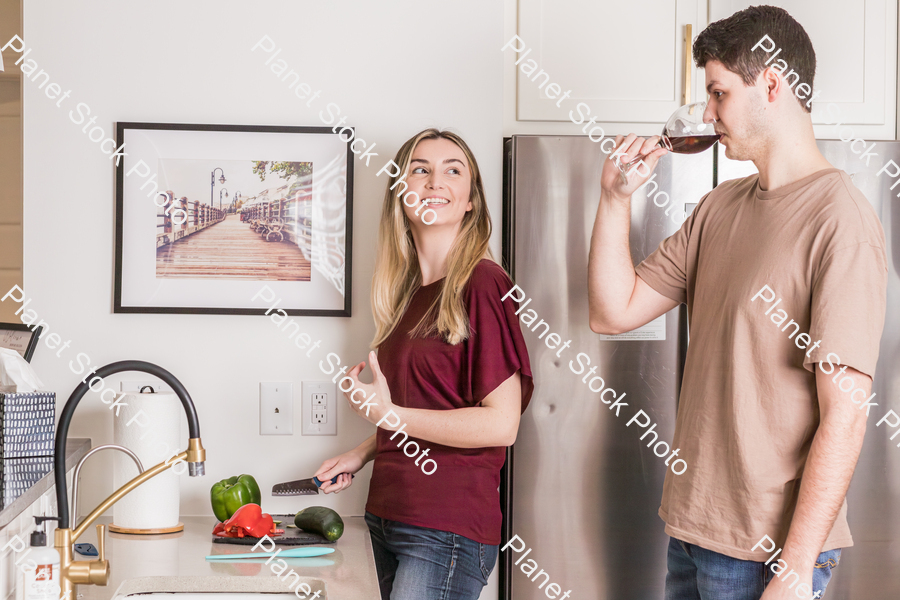 A young couple preparing a meal in the  kitchen stock photo with image ID: 5a2d0387-6260-41f6-a948-50848782cb1c