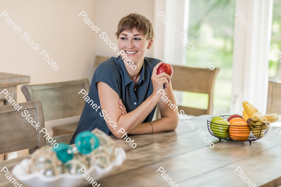 A young lady grabbing fruit stock photo with image ID: 5aeb9742-b23e-4fff-9f83-3567ee1d742d