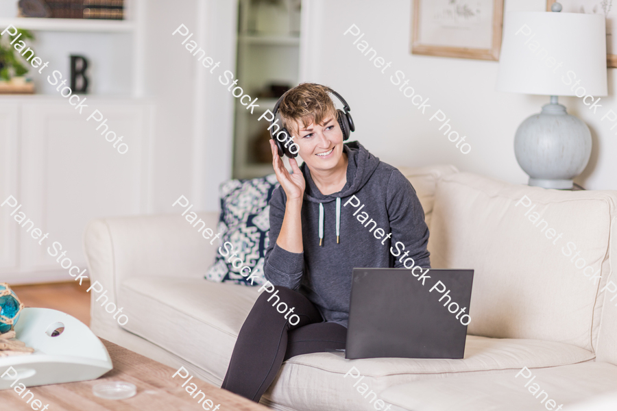 A young lady sitting on the couch stock photo with image ID: 5bf92203-4f93-4820-a917-96a86c339c8c