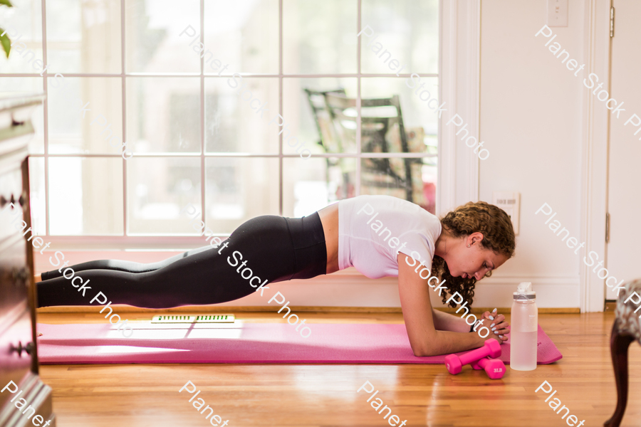 A young lady working out at home stock photo with image ID: 5c645a05-965e-46b8-964a-9c6046dea12c