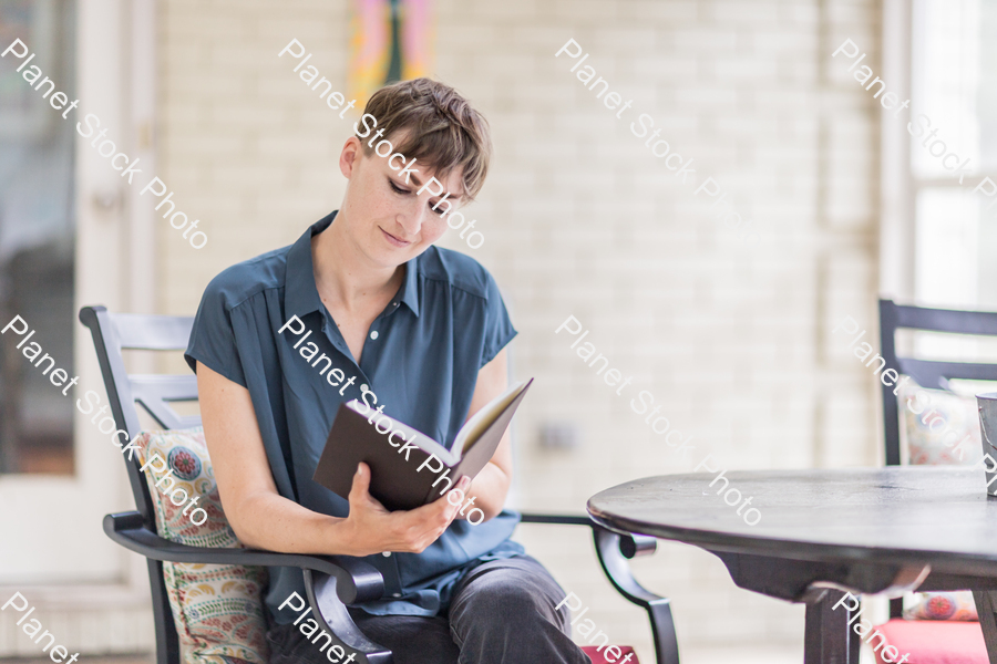 A young lady enjoying daylight at home stock photo with image ID: 5db29cdb-bb56-44f5-a977-e933d807ae15