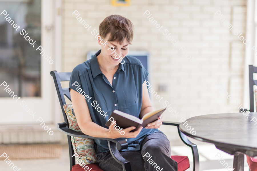 A young lady enjoying daylight at home stock photo with image ID: 5df83fdb-23de-467a-9f62-7f3d25a18c99