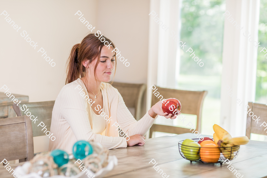 A young lady grabbing fruit stock photo with image ID: 5ff266c1-9354-4e33-9ee2-45c36ab5cb07