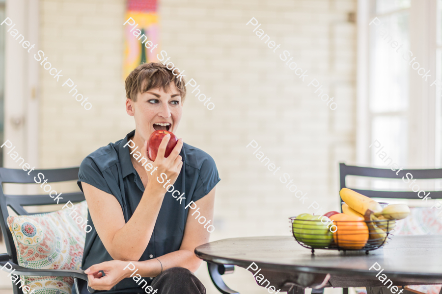 A young lady enjoying daylight at home stock photo with image ID: 6031ae05-637c-4cdd-bb30-052d7141a646