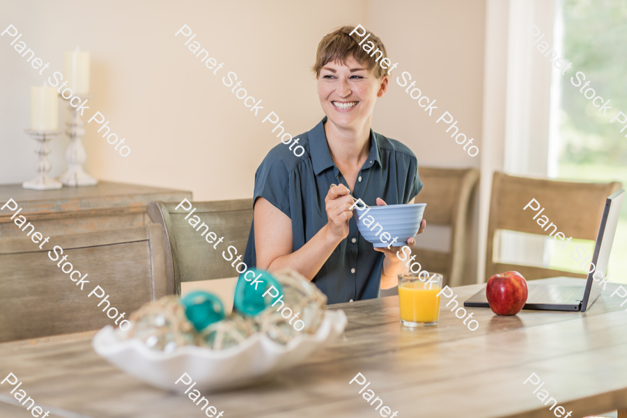 A young lady having a healthy breakfast stock photo with image ID: 615aa63e-d38b-40da-b3f2-a81de0272531