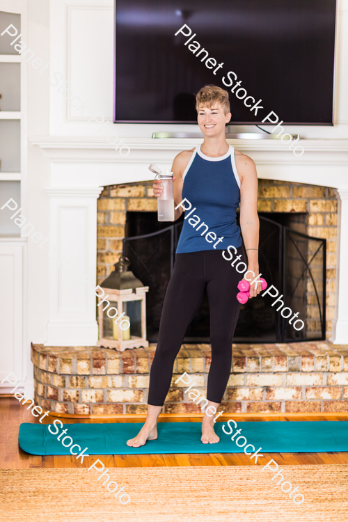 A young lady working out at home stock photo with image ID: 619faa8a-c8fd-4d77-b900-e425cd94bf9e