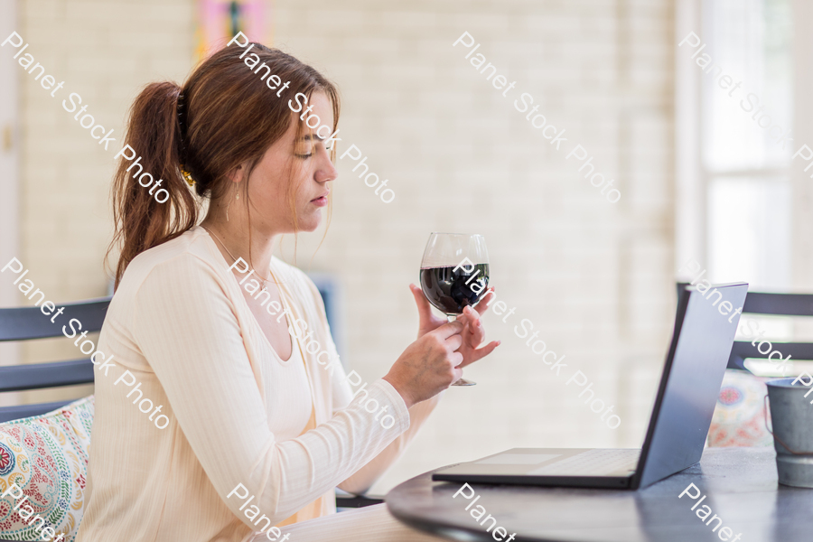 A young lady enjoying daylight at home stock photo with image ID: 620ab0d9-9c2e-45f7-8b80-99da2172a931