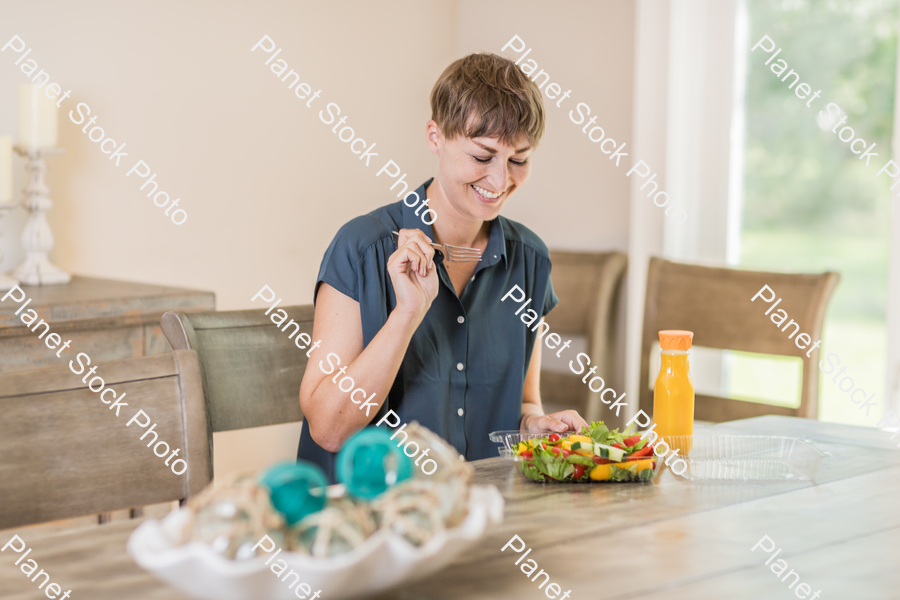 A young lady having a healthy meal stock photo with image ID: 62555c5f-d609-4638-9d2a-4ebd483aec19