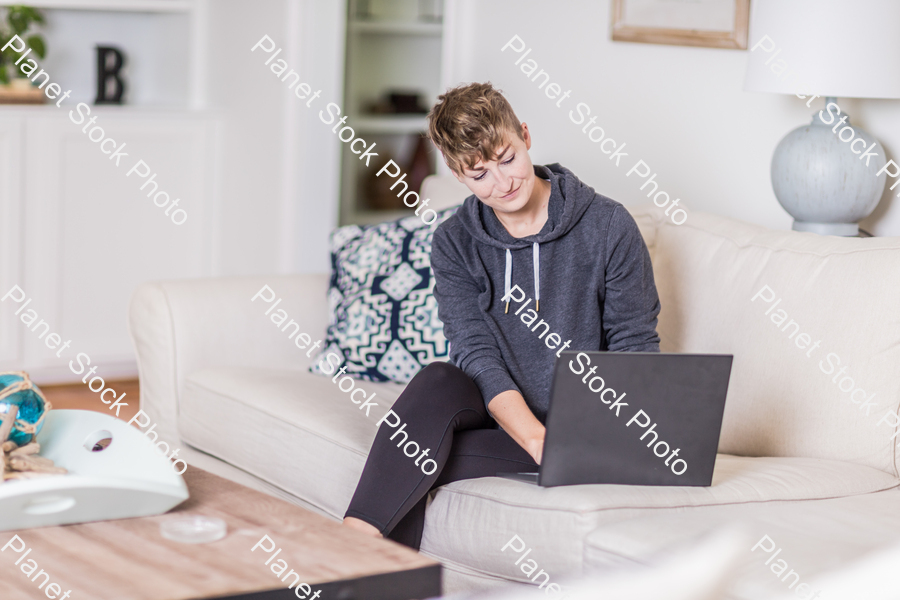 A young lady sitting on the couch stock photo with image ID: 62f43792-4077-4188-97bd-15e8e1c0d857