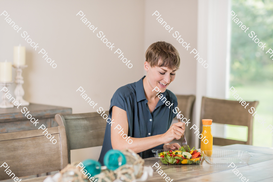 A young lady having a healthy meal stock photo with image ID: 63ab1230-9f65-49ef-b885-e609f76a9d70