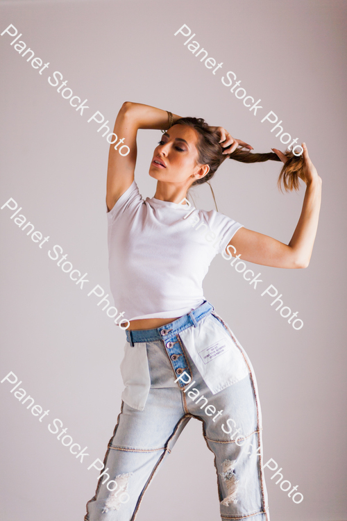 Model in blue jeans and t-shirt, posing for a studio photoshoot stock photo with image ID: 63bf8ce2-412f-4b39-b5dc-4566588ee4c8